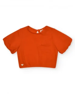 Camiseta naranja para niña con flor y mangas abullonadas