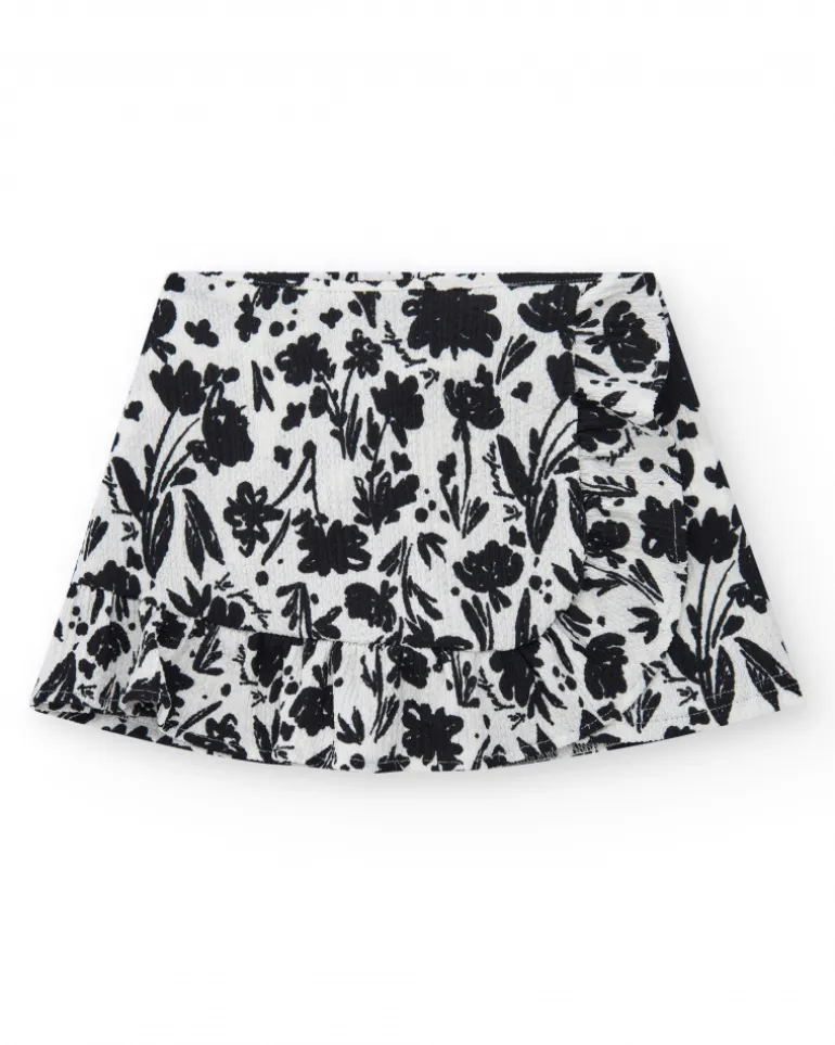 Falda para niña en blanco con estampado floral y volante