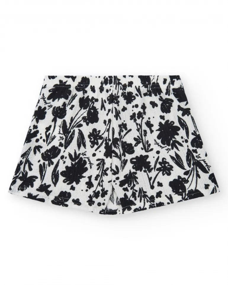 Falda para niña en blanco con estampado floral y volante