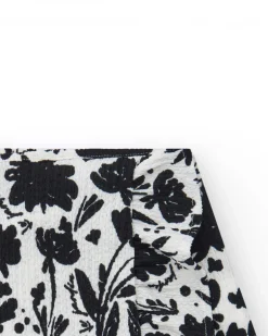 Falda para niña en blanco con estampado floral y volante