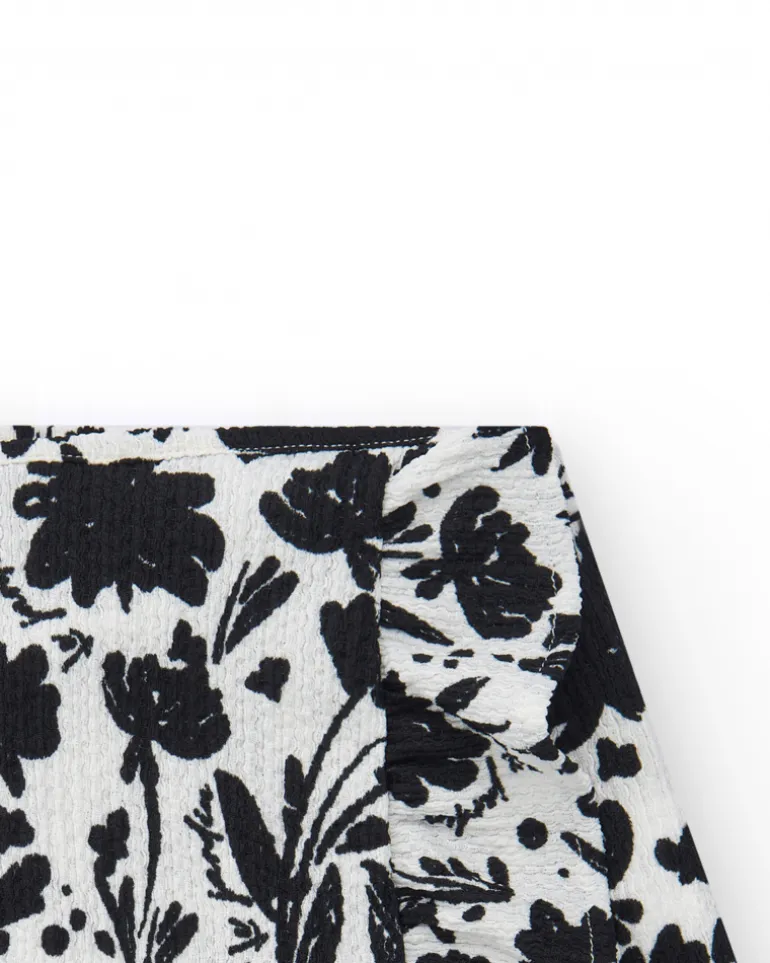 Falda para niña en blanco con estampado floral y volante