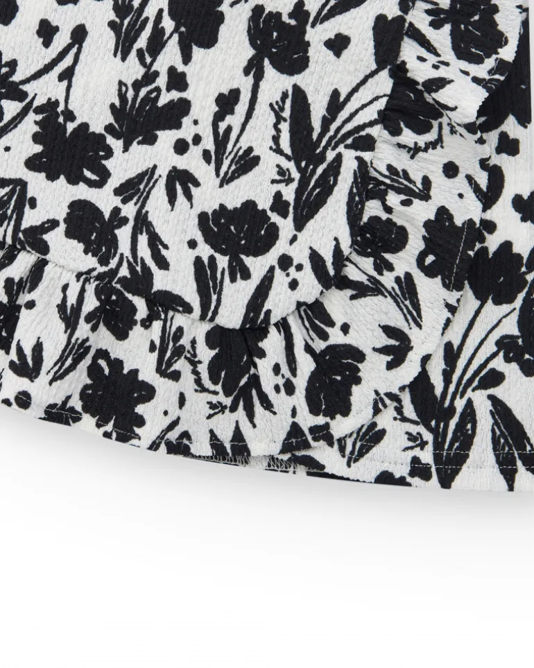 Falda para niña en blanco con estampado floral y volante